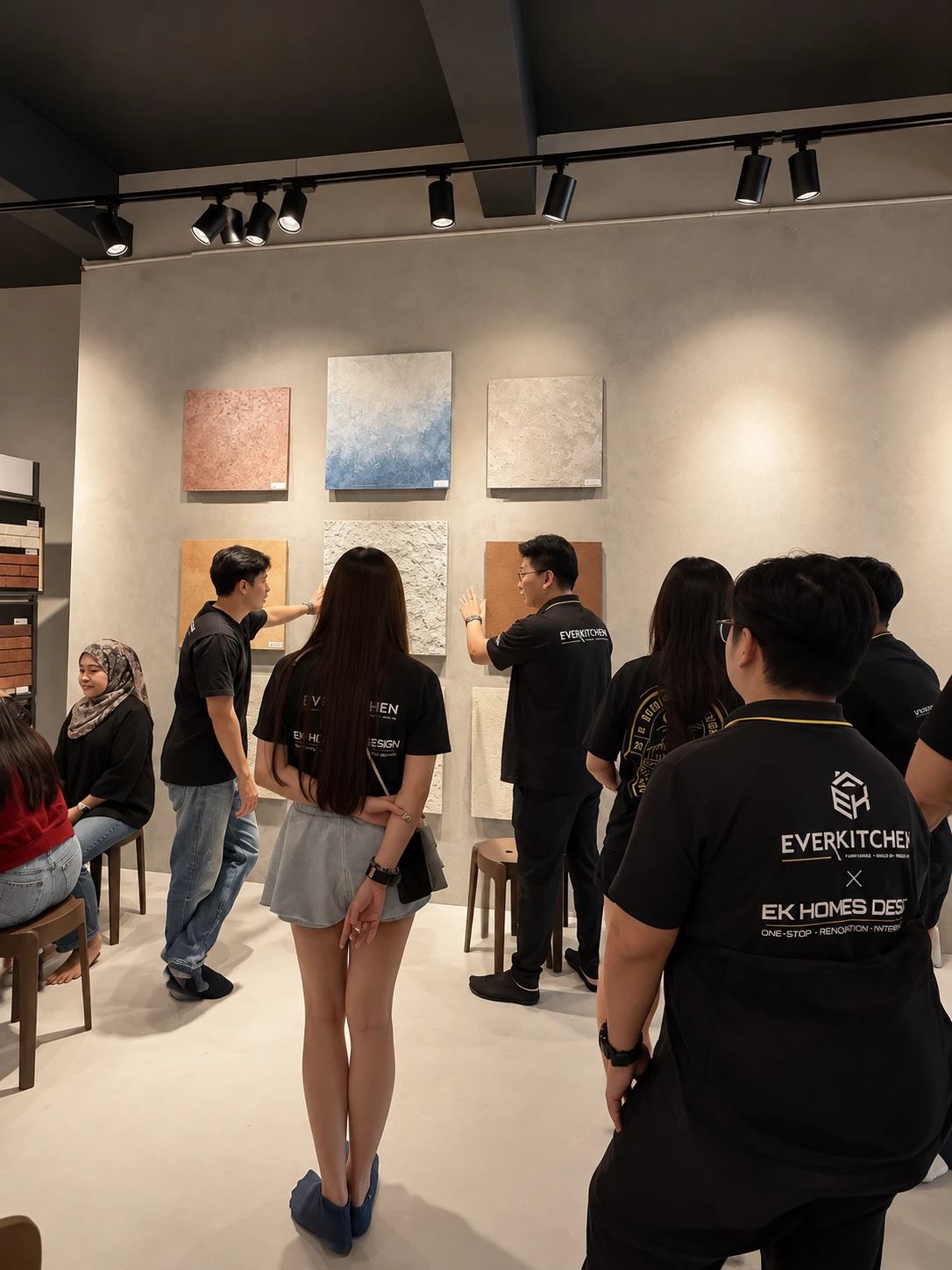 A design team gathered at the sample wall during a Designer Day session
